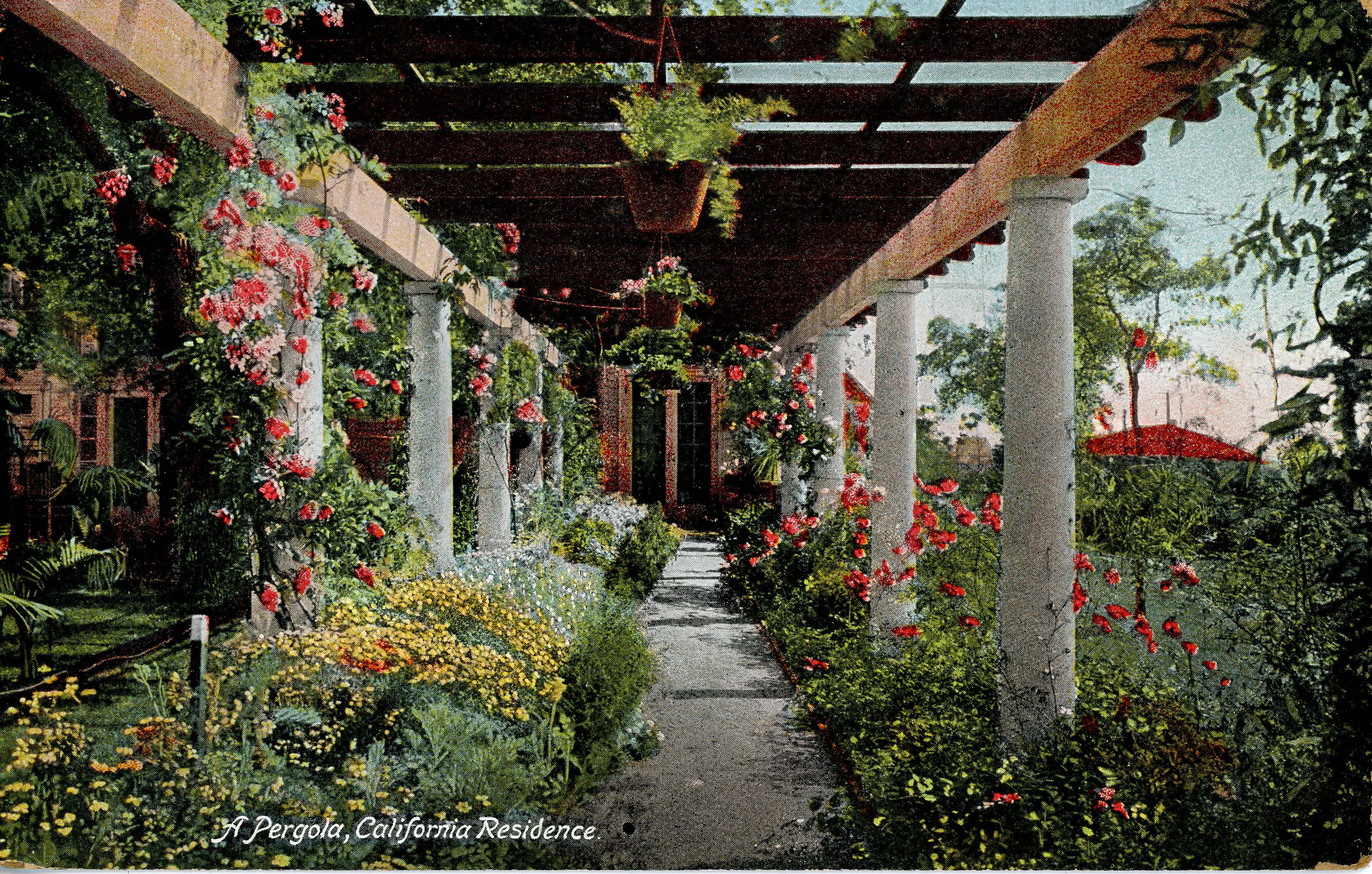 An image of a pergola draped with flowers and greenery